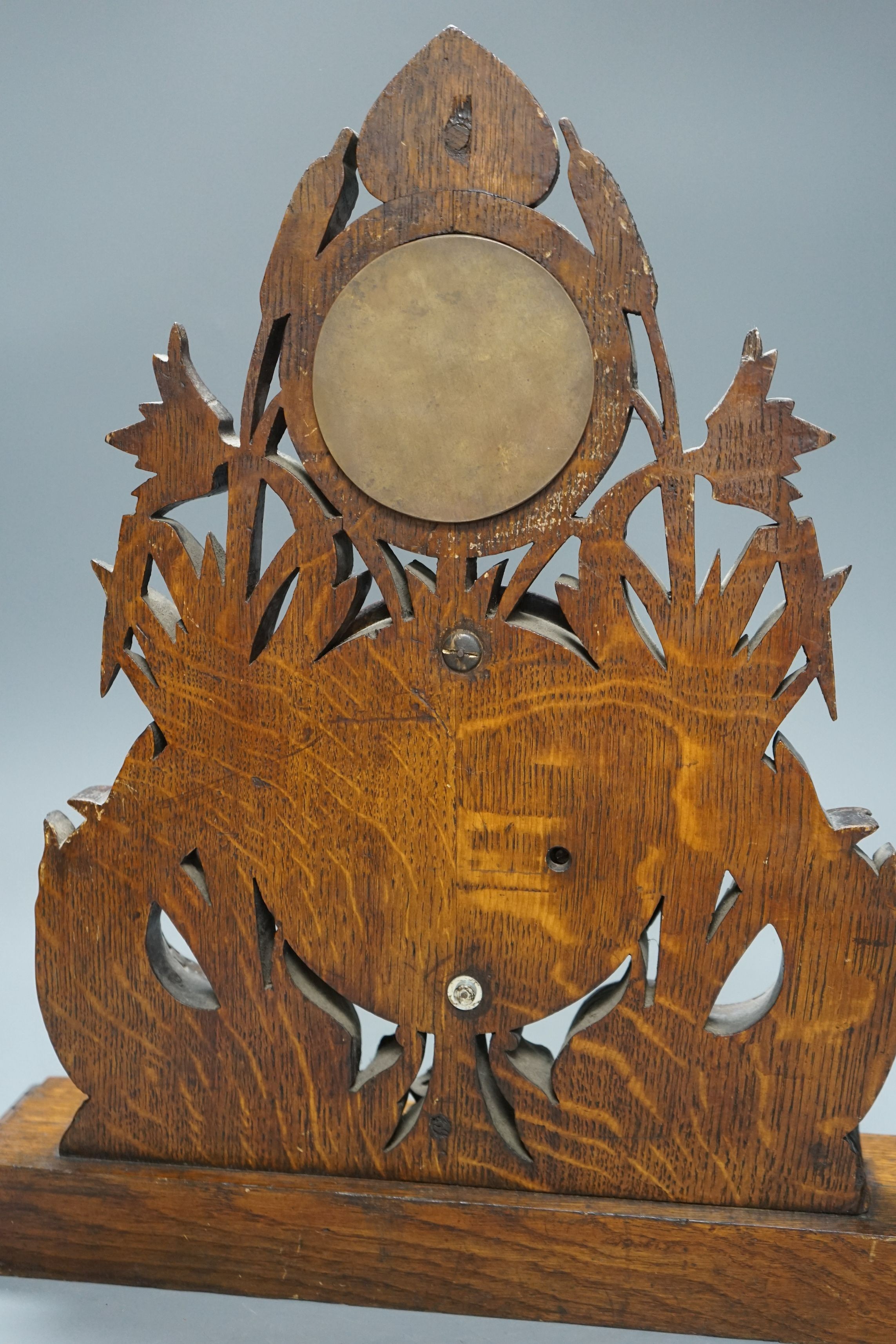 A Victorian oak timepiece combined barometer by Salom & Co., carved with stylised fish and bull rushes, height 46cm